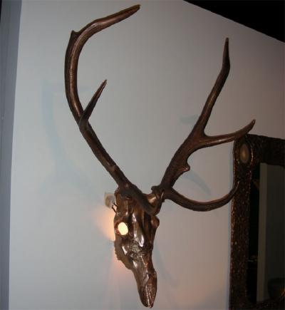 Two 1970s sconces shaped like a deers skull with antlers