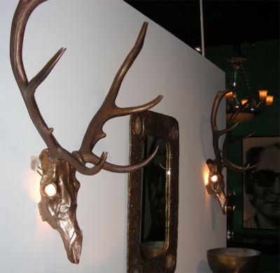 Two 1970s sconces shaped like a deers skull with antlers