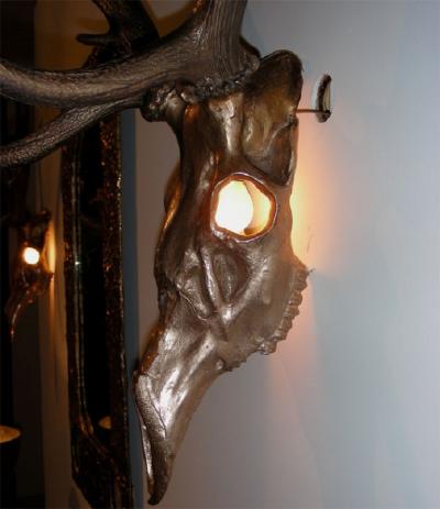 Two 1970s sconces shaped like a deers skull with antlers