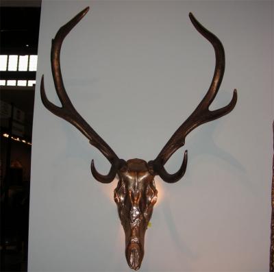 Two 1970s sconces shaped like a deers skull with antlers
