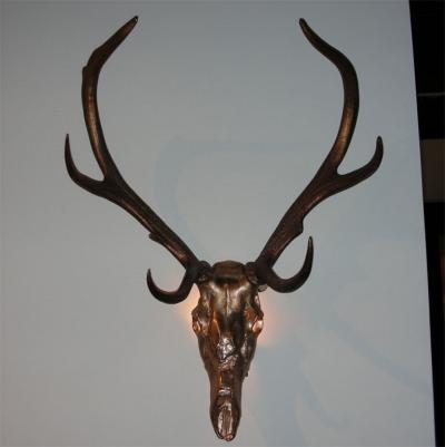 Two 1970s sconces shaped like a deers skull with antlers