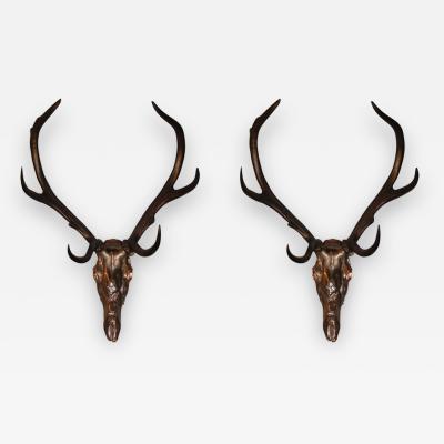 Two 1970s sconces shaped like a deers skull with antlers