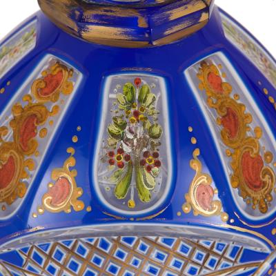 Two Bohemian enamelled blue overlay cut glass decanters