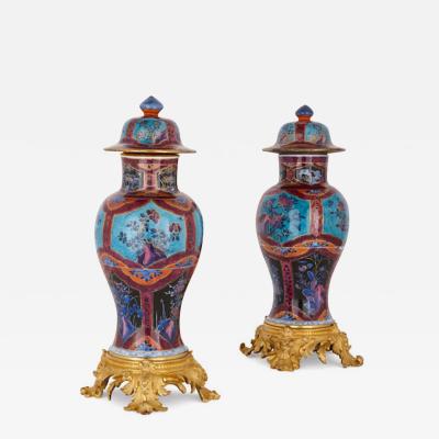 Two Chinese Qing dynasty porcelain vases with gilt bronze bases