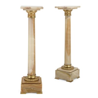 Two French white onyx and gilt bronze column shaped stands