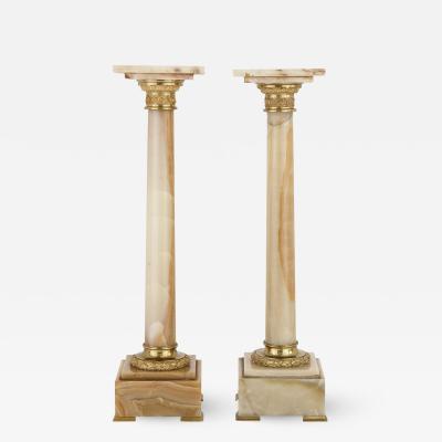 Two French white onyx and gilt bronze column shaped stands