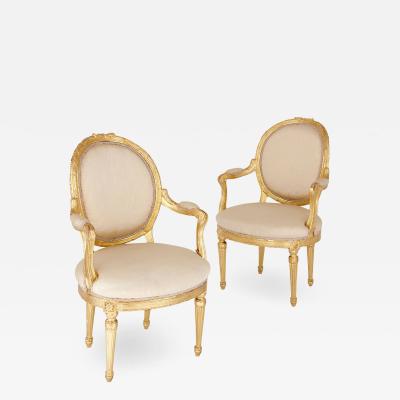 Two Louis XVI style giltwood upholstered fauteuil armchairs