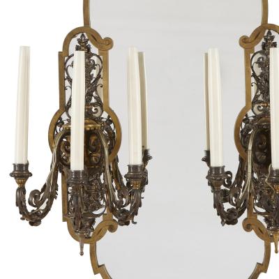 Two Rococo style gilt and silvered metal girandoles