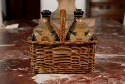 Two Victorian English Pottery Decanters in Tantalus Inspired Wicker Basket
