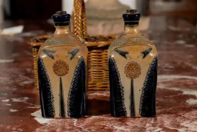 Two Victorian English Pottery Decanters in Tantalus Inspired Wicker Basket