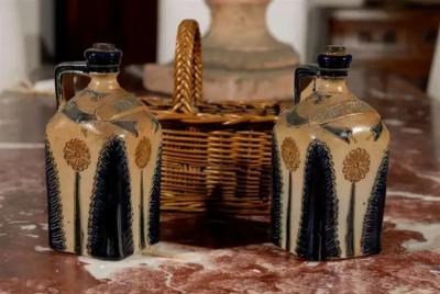 Two Victorian English Pottery Decanters in Tantalus Inspired Wicker Basket