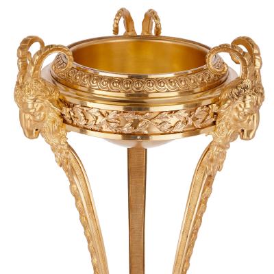 Two antique Neoclassical style gilt bronze tripod stands