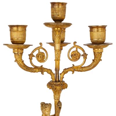 Two early 19th Century French Empire gilt bronze candelabra