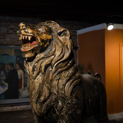 Two large life sized polychromed lion head wooden statues 