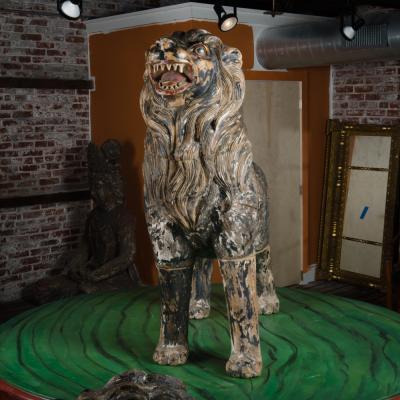 Two large life sized polychromed lion head wooden statues 