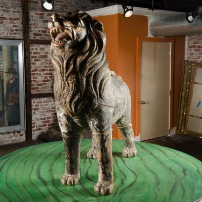Two large life sized polychromed lion head wooden statues 