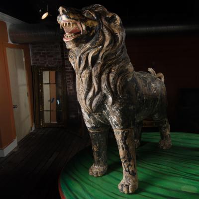 Two large life sized polychromed lion head wooden statues 