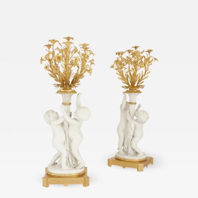 Two monumental biscuit porcelain and gilt bronze candelabra