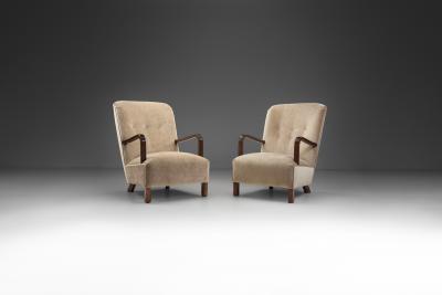Upholstered Lounge Chairs with Sculptural Arms Europe ca 1940s
