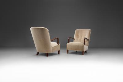 Upholstered Lounge Chairs with Sculptural Arms Europe ca 1940s