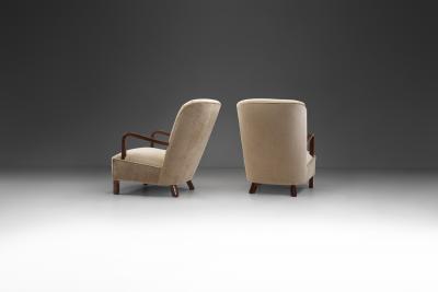 Upholstered Lounge Chairs with Sculptural Arms Europe ca 1940s