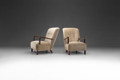 Upholstered Lounge Chairs with Sculptural Arms Europe ca 1940s