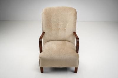 Upholstered Lounge Chairs with Sculptural Arms Europe ca 1940s