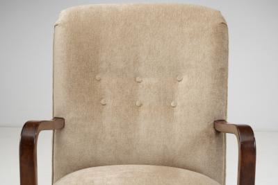 Upholstered Lounge Chairs with Sculptural Arms Europe ca 1940s