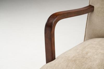Upholstered Lounge Chairs with Sculptural Arms Europe ca 1940s
