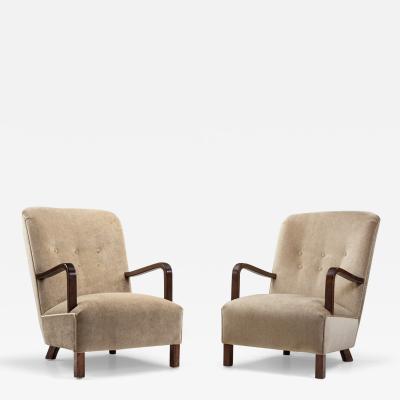 Upholstered Lounge Chairs with Sculptural Arms Europe ca 1940s