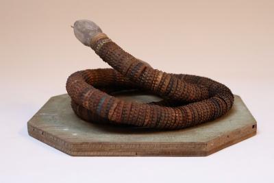Vintage Folk Art Hand Carved Wood and Bottlecap Snake on Octagonal Base