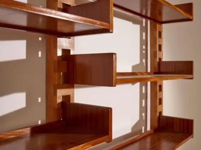 Wall mounted bookcase with wooden uprights and modules Italy 1950s