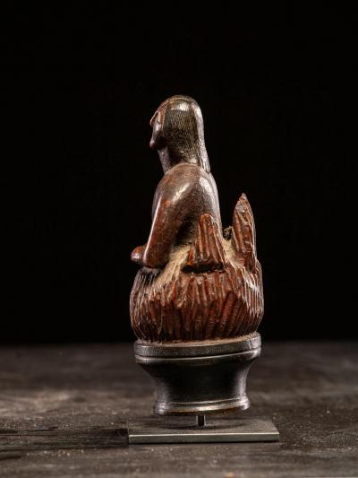 Wooden folk art figure depicting a stylized feminine soul burning in Purgatory
