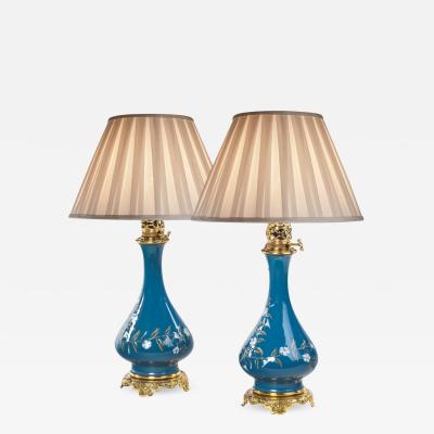 pair of French pate sur pate ceramic oil lamps