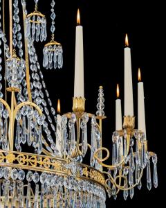  Werner Mieth A GERMAN NEOCLASSICAL SILVER AND GILT BRONZE TWELVE LIGHT CRYSTAL CHANDELIER - 3788087