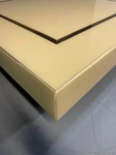 1970s Acrylic Stepped Cream Colored Coffee Table with Brass Ribbon Inlay - 3245047