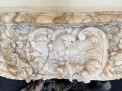A Finely Carved Louis XV Style Fireplace Mantel in Figured Italian Marbl - 4587404