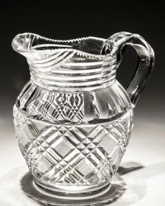 A HEAVILY CUT GLASS CREAM JUG - 4340883