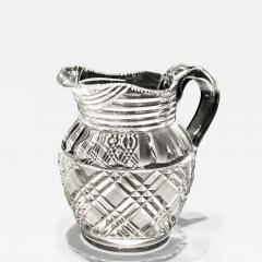 A HEAVILY CUT GLASS CREAM JUG - 4344272