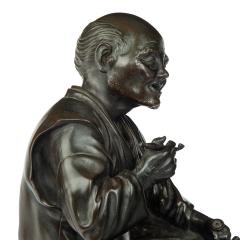 A Meiji period bronze of a seated man smoking - 3456857