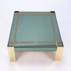 A Mid Century Modern coffee table with brass legs and trim Circa 1970 - 2348625