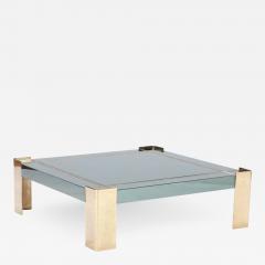 A Mid Century Modern coffee table with brass legs and trim Circa 1970 - 2352282