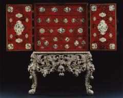 A RED LACQUERED CABINET WITH SHAPED PANELS - 3424385