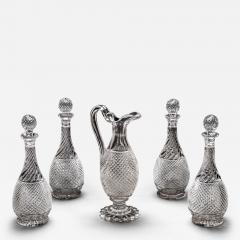 A SET OF FOUR DIAMOND SWIRL CUT DECANTERS WITH CORRESPONDING WINE EWER - 3789346