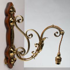 A Set of Three Arts Crafts Brass Wall Lights with Walnut Backplates - 4192509