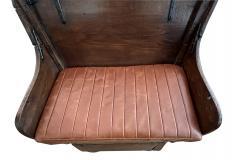 A carved mixed wood wagon seat now as a bench - 2856220