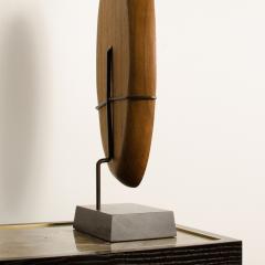 A carved wood almond shaped sculpture and base - 2033536
