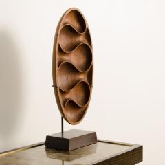 A carved wood almond shaped sculpture and base - 2033615