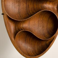 A carved wood almond shaped sculpture and base - 2033627