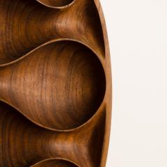 A carved wood almond shaped sculpture and base - 2033629